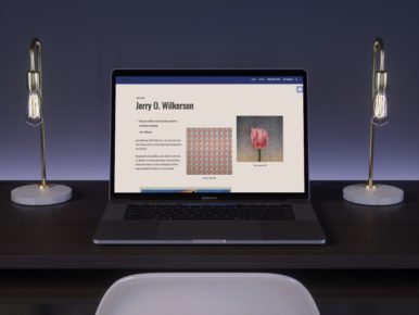 mockup of jerry wilkerson home page on laptop between two lamps